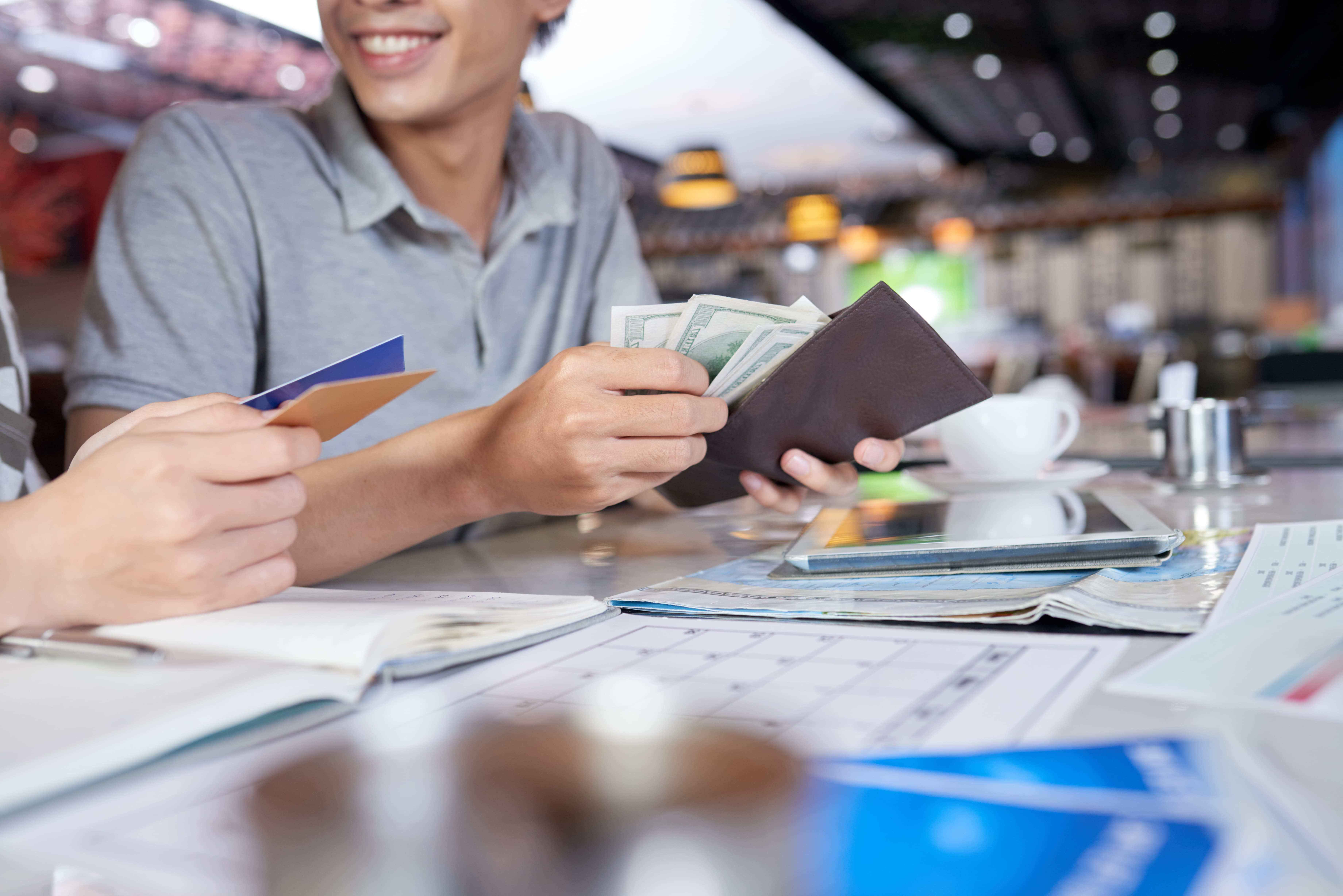 Cropped people checking their wallet money bank card min